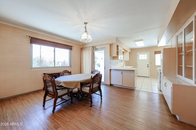 dining space featuring a wealth of natural light and brick wall