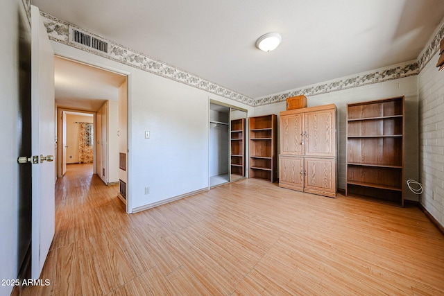 unfurnished bedroom featuring visible vents, baseboards, and a closet