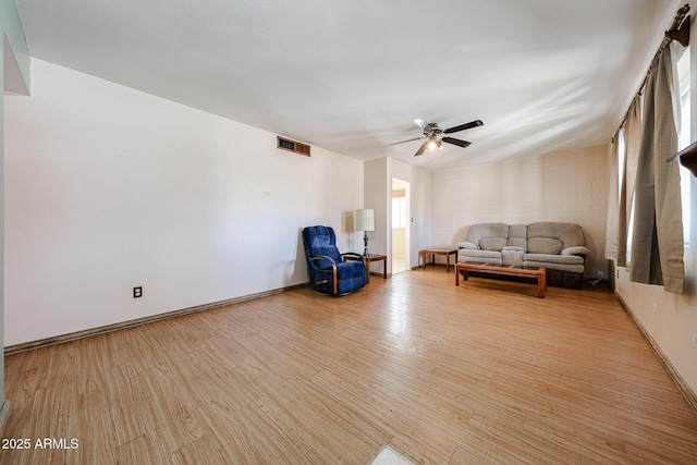 unfurnished room with ceiling fan, visible vents, baseboards, and light wood-style flooring