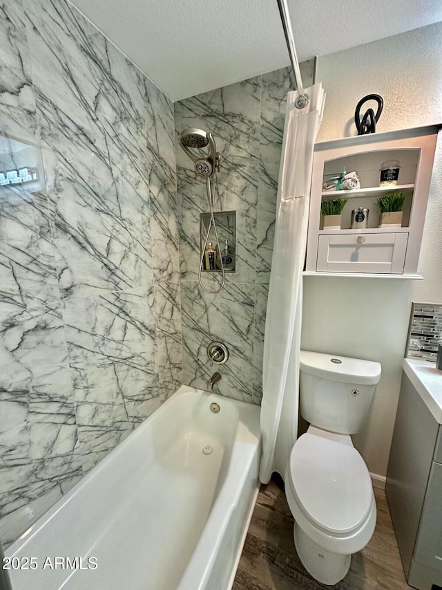 bathroom with shower / tub combo with curtain, hardwood / wood-style flooring, a textured ceiling, and toilet