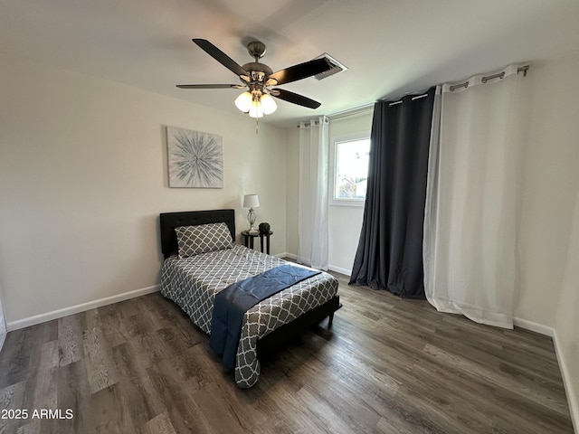 bedroom with dark hardwood / wood-style floors and ceiling fan