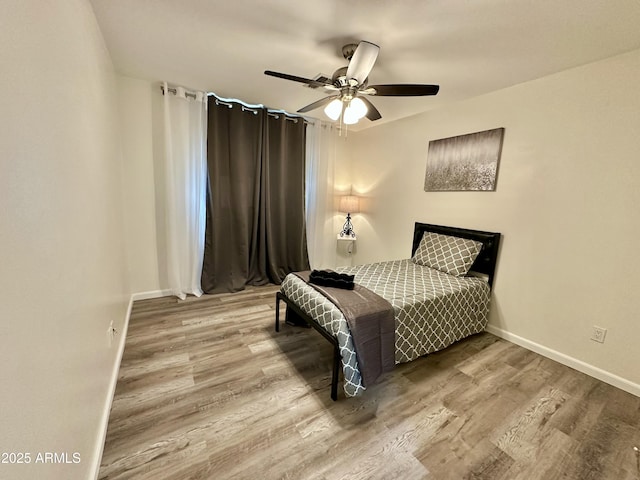 bedroom featuring ceiling fan and wood-type flooring