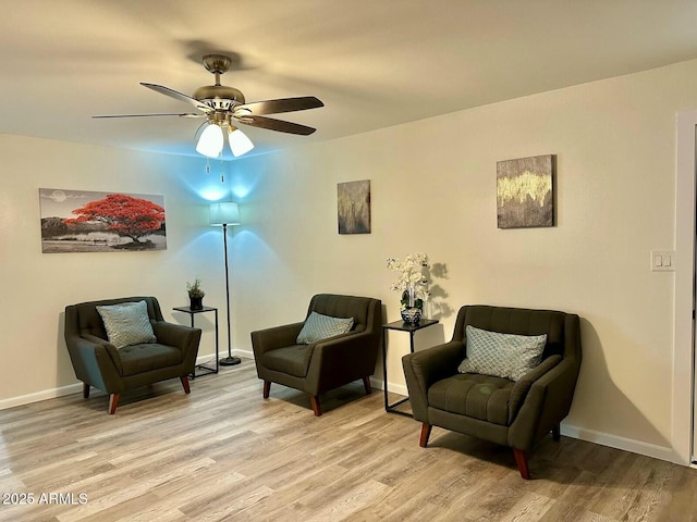 sitting room featuring ceiling fan and light wood-type flooring