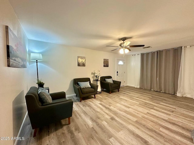 living area featuring ceiling fan and light hardwood / wood-style floors