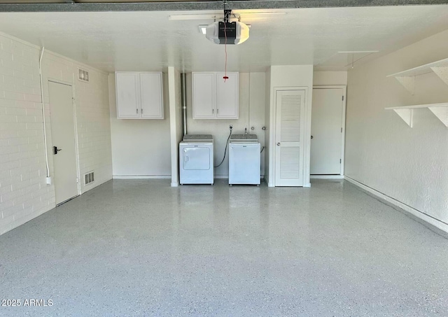 garage featuring a garage door opener and washer and dryer