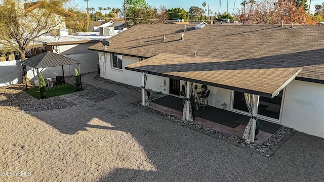 back of property with a gazebo and a patio area