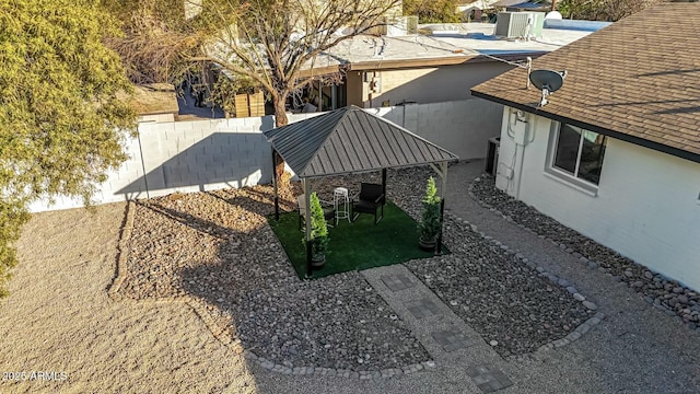 view of yard featuring a gazebo and central AC