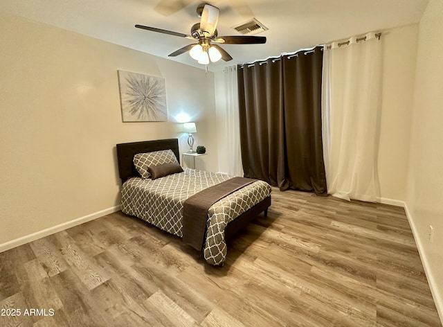 bedroom featuring wood-type flooring and ceiling fan