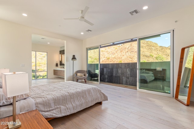 bedroom featuring ceiling fan, access to outside, light hardwood / wood-style floors, and multiple windows