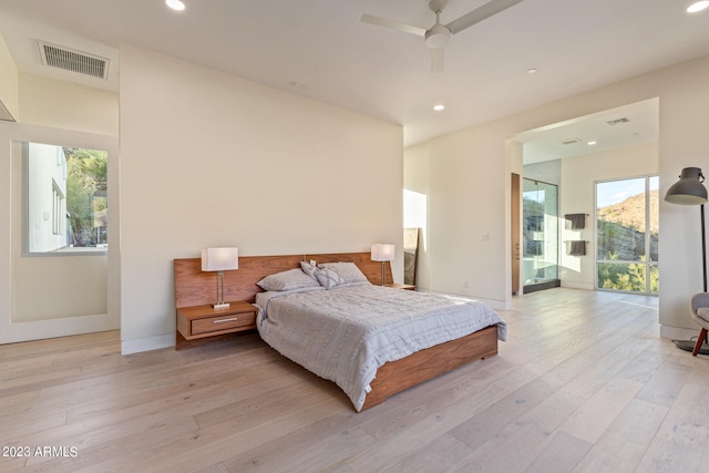 bedroom featuring ceiling fan, light hardwood / wood-style flooring, and access to outside