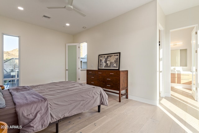 bedroom with ceiling fan, light wood-type flooring, and ensuite bathroom