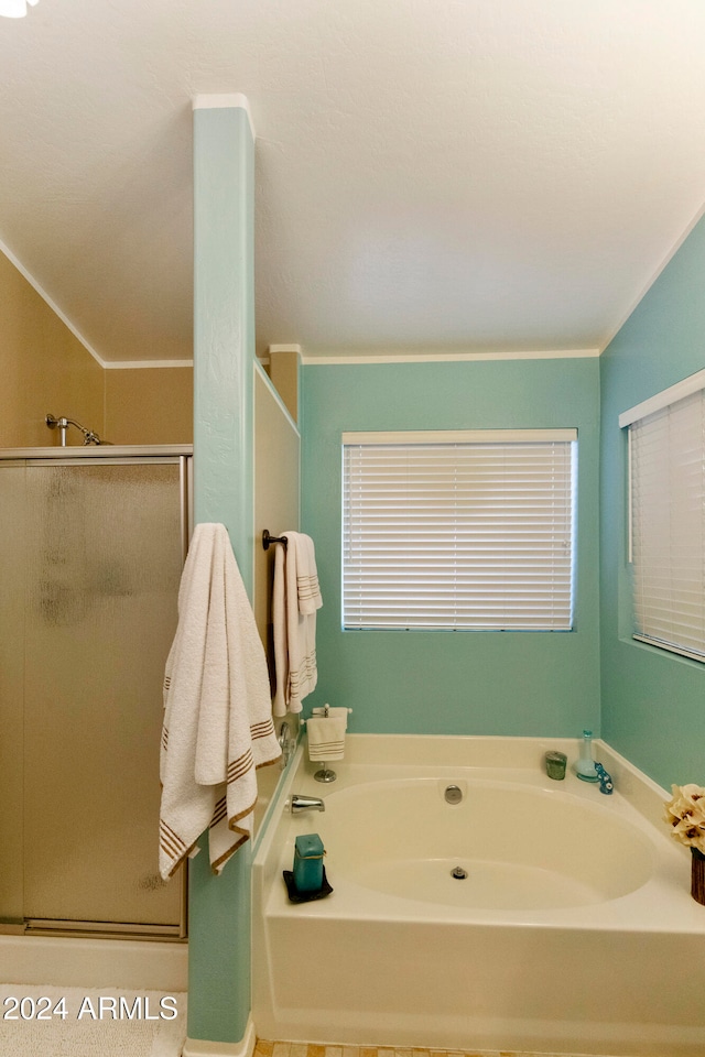 bathroom with crown molding and shower with separate bathtub