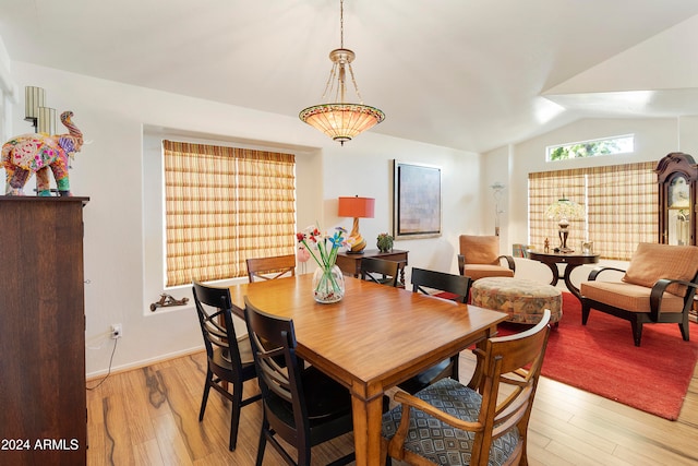 dining area featuring light hardwood / wood-style floors and lofted ceiling