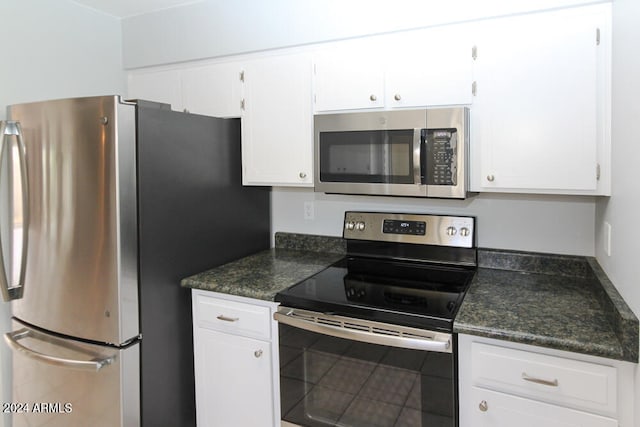 kitchen featuring stainless steel appliances and white cabinetry