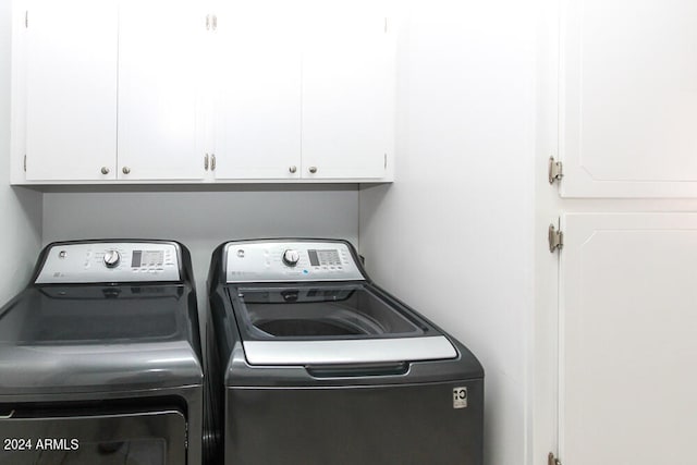 laundry area featuring cabinets and washing machine and clothes dryer