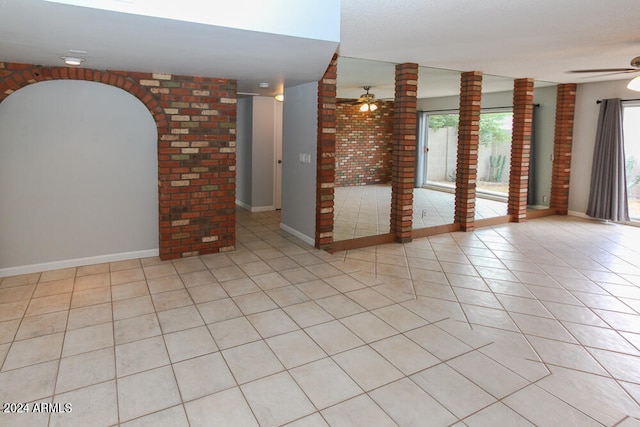 spare room featuring ceiling fan and light tile patterned floors