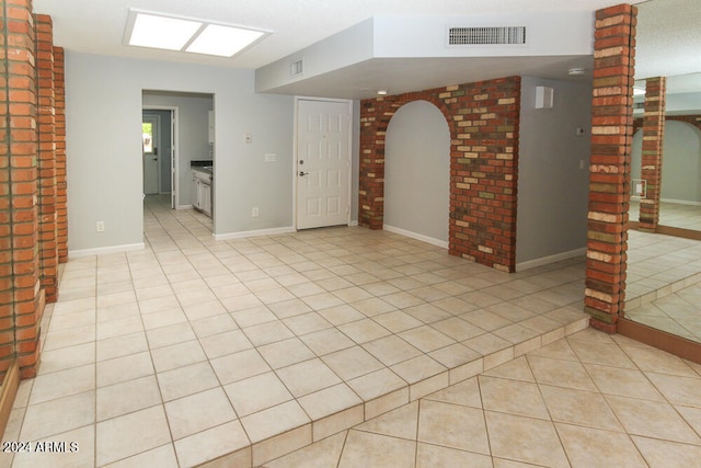 unfurnished room featuring light tile patterned floors