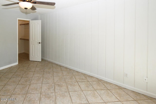 tiled empty room with ceiling fan