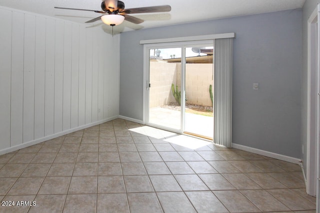 tiled empty room featuring ceiling fan and a textured ceiling