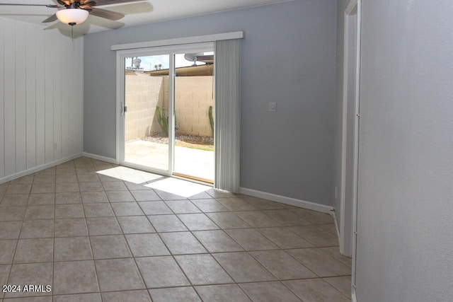 tiled spare room featuring ceiling fan