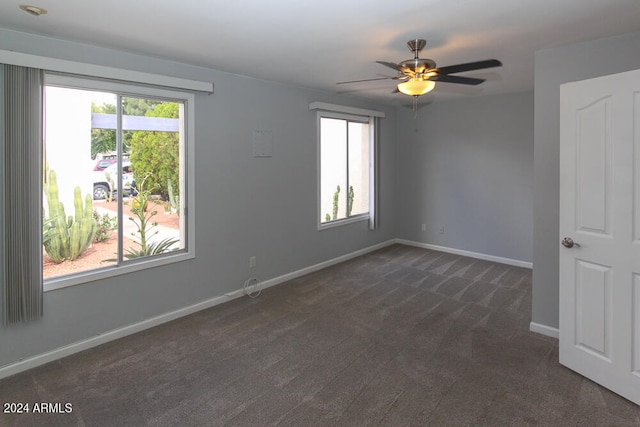 carpeted empty room with ceiling fan and a healthy amount of sunlight