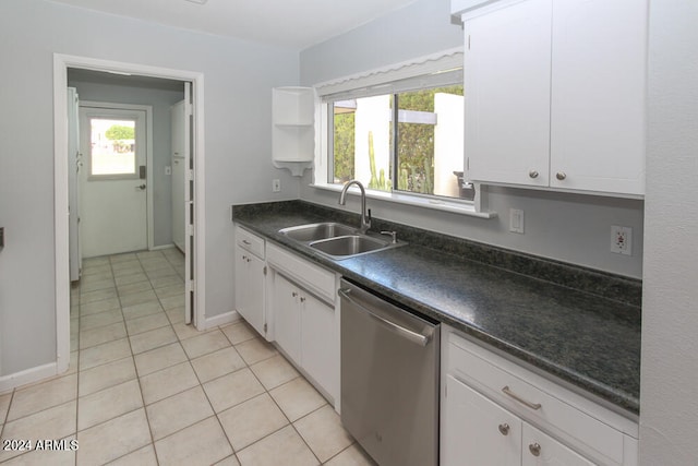 kitchen with stainless steel dishwasher, white cabinetry, sink, and light tile patterned flooring