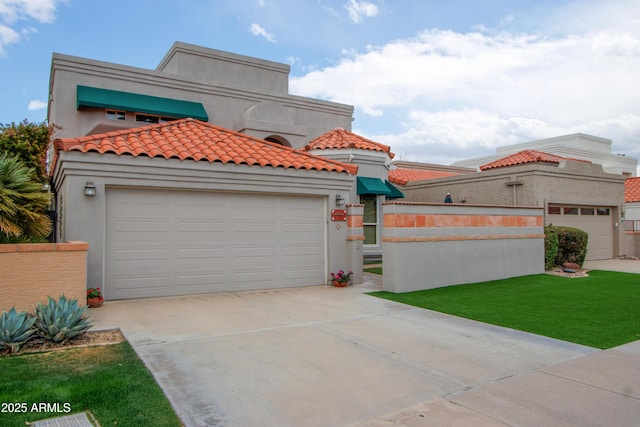 mediterranean / spanish home with a front lawn and a garage