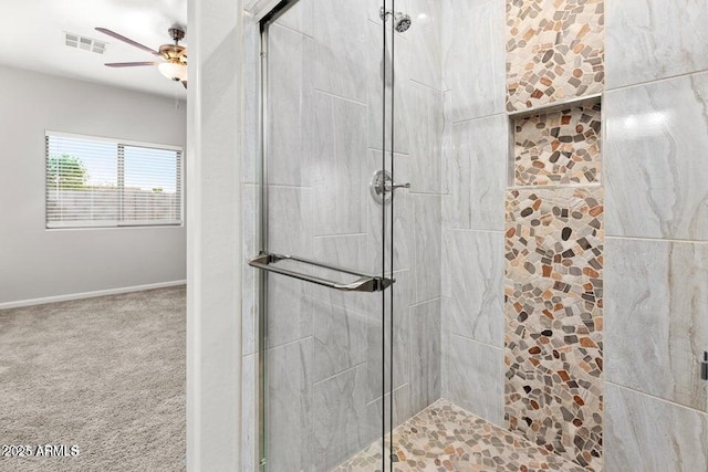 bathroom featuring a ceiling fan, a stall shower, visible vents, and baseboards