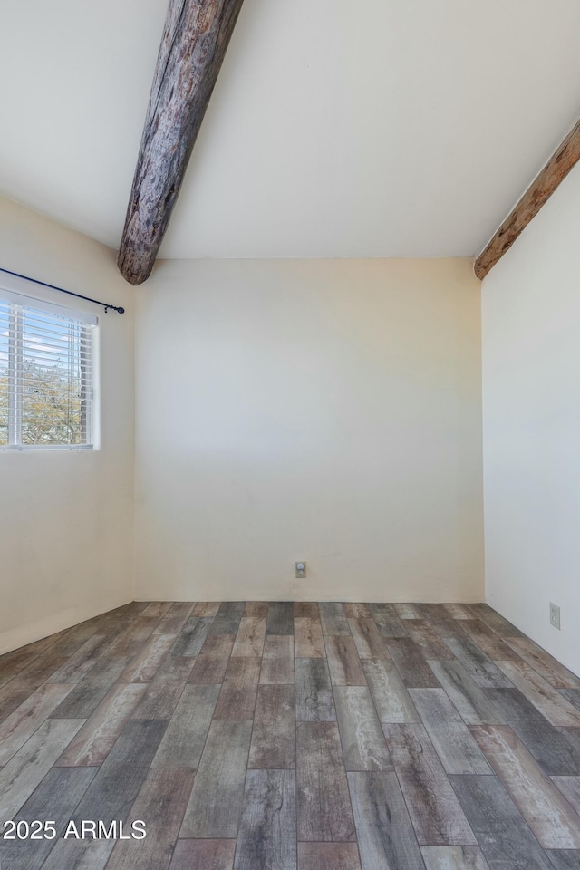 empty room with beam ceiling and dark hardwood / wood-style floors