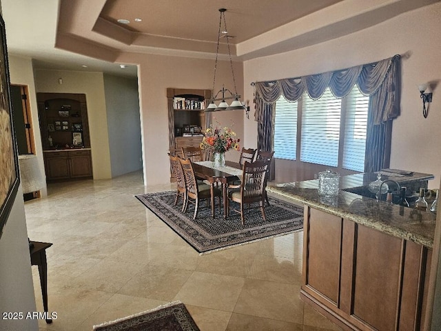 dining room featuring a raised ceiling