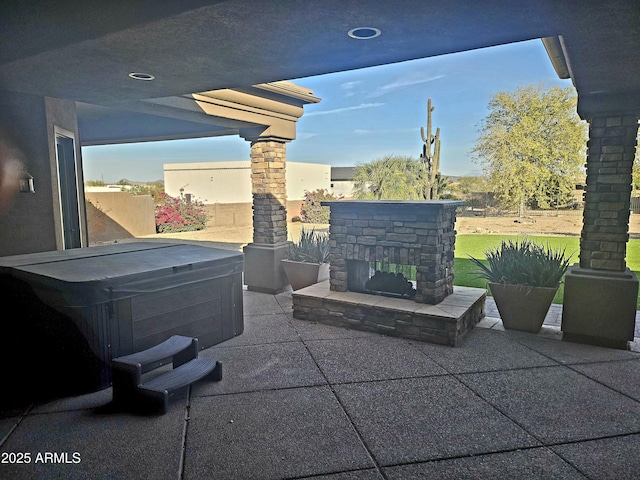 view of patio with an outdoor stone fireplace