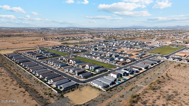 aerial view of property's location with nearby suburban area and a mountainous background
