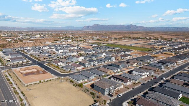 aerial view of property and surrounding area featuring a mountainous background and nearby suburban area