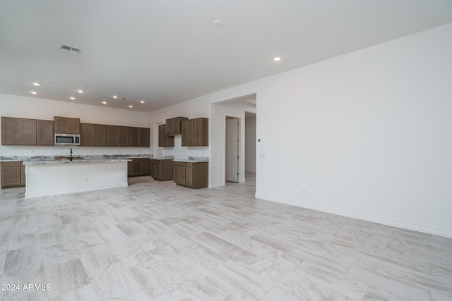 kitchen with a kitchen island with sink