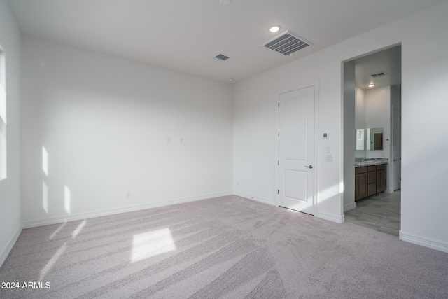 unfurnished room featuring light carpet