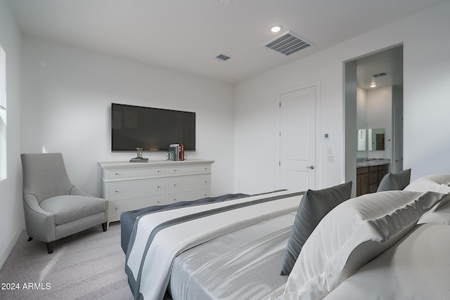 carpeted bedroom featuring ensuite bathroom