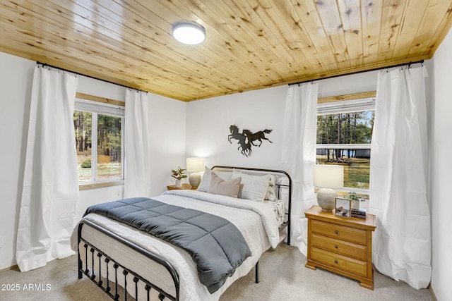 bedroom with wood ceiling and carpet floors