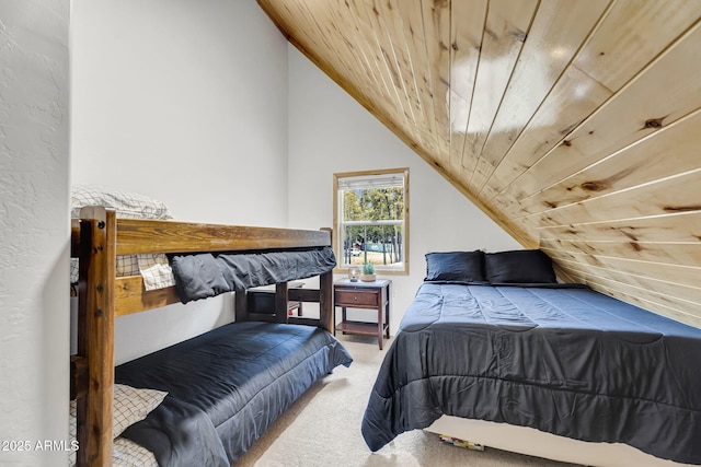 carpeted bedroom with vaulted ceiling and wooden ceiling