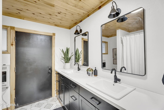 bathroom featuring heating unit, double vanity, wood ceiling, and a sink