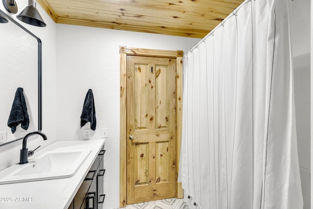 bathroom with vanity and wooden ceiling