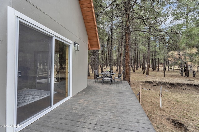 wooden terrace with outdoor dining area