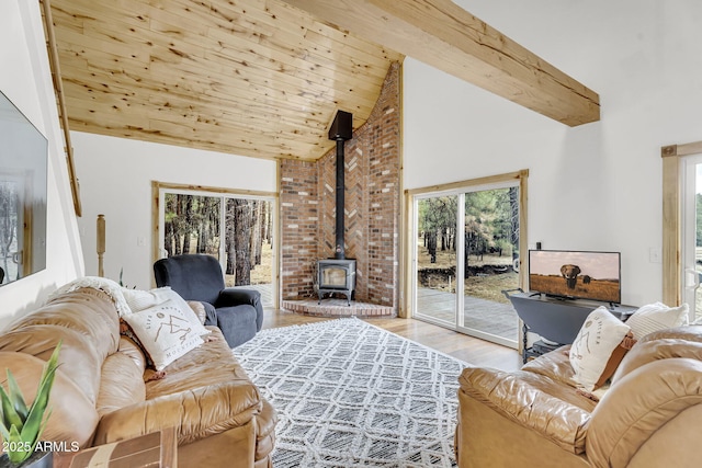 living area featuring wood ceiling, high vaulted ceiling, wood finished floors, a wood stove, and beam ceiling