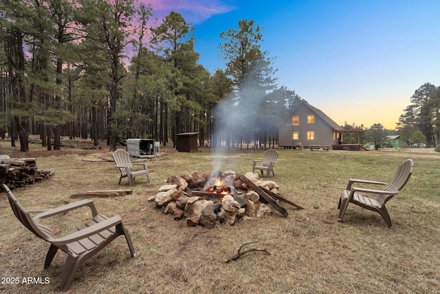 surrounding community with a yard and a fire pit