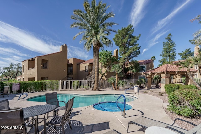 view of pool with fence, a patio, and a residential view