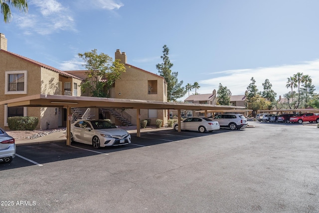 covered parking lot featuring stairs