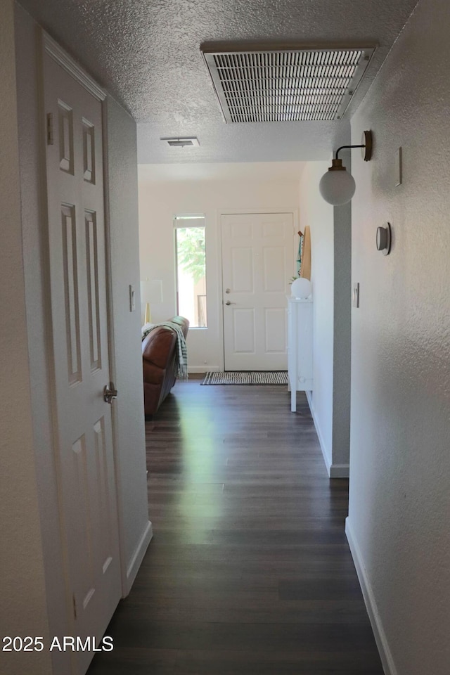 8787 E Mountain View Rd Unit 2008, Scottsdale, AZ 85258 - hallway with baseboards, dark wood finished floors, a textured wall, and a textured ceiling