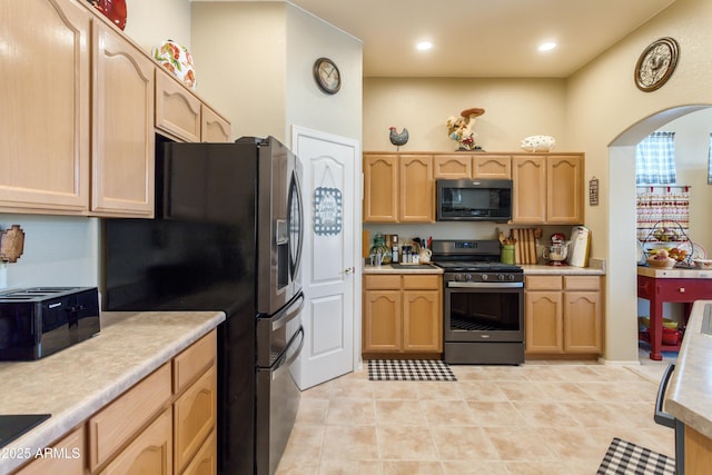 2675 Tarina Way, Sierra Vista, AZ 85650 - kitchen featuring stainless steel gas range oven, arched walkways, light brown cabinetry, light countertops, and recessed lighting
