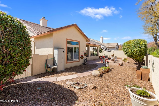 2675 Tarina Way, Sierra Vista, AZ 85650 - rear view of house with stucco siding, a fenced backyard, a chimney, a patio area, and a tiled roof