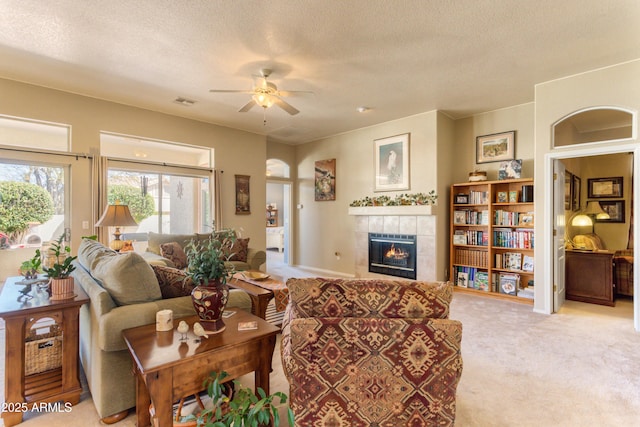 2675 Tarina Way, Sierra Vista, AZ 85650 - living area with a fireplace, a ceiling fan, carpet floors, and a textured ceiling