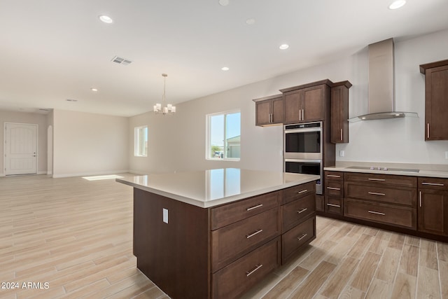 kitchen featuring stainless steel double oven, black electric stovetop, light countertops, and wall chimney exhaust hood